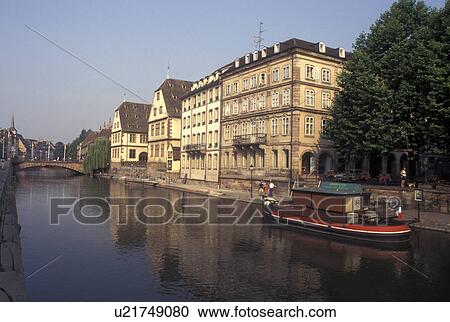 Stock Image -  France, Alsace, Strasbourg, Bas-Rhin, Europe, wine region, Barge along the Ill River in the city of Strasbourg, the capital of Bas-Rhin, in the wine region of Alsace.. Fotosearch