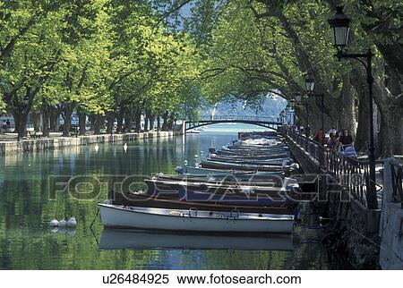 France, Annecy, Haute-Savoie, Rhone-Alpes, Europe, Wooden rowboats docked along the tree-lined Vasse canal on scenic Lake Annecy (Lac d' Annecy) in Annecy. View Large Photo Image Stock Photography - France, Annecy, Haute-Savoie, Rhone-Alpes, Europe, Wooden rowboats docked along the tree-lined Vasse canal on scenic Lake Annecy (Lac d' Annecy) in Annecy. . Fotosearch