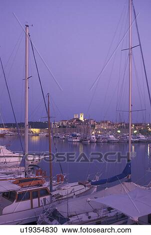 Stock Image -  France, Antibes, Cote d' Azur, Provence, Alpes-Maritimes, Europe, Boats docked in Port Vauban Harbor on the Mediterranean Sea in the city of Antibes in the early morning.. Fotosearch