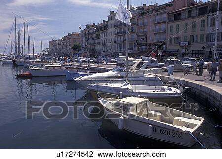 Stock Image -  France, Cannes, Cote d' Azur, Provence, Alpes-Maritimes, Europe, Boats docked at the marina along the waterfront of Cannes on the Mediterranean Sea.. Fotosearch