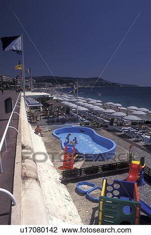 Stock Image -  France, Nice, beach, Cote d' Azur, Provence, Alpes-Maritimes, Europe, A view of the beach along the Mediterranean Sea in the city of Nice.. Fotosearch