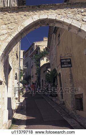 France, St. Paul de Vence, Cote d' Azur, Provence, Alpes-Maritimes, Europe, View of shops along a narrow cobbled street from an archway in the hilltop village of Saint Paul de Vence. View Large Photo Image Stock Photo - France, St. Paul de Vence, Cote d' Azur, Provence, Alpes-Maritimes, Europe, View of shops along a narrow cobbled street from an archway in the hilltop village of Saint Paul de Vence.. Fotosearch