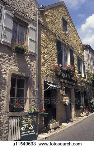 Stock Image -  France, Vezelay, Burgundy, Yonne, wine region, Bourgogne, Europe, Shops along a narrow street in Vezelay in the wine region of Burgundy.. Fotosearch