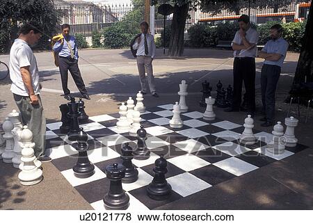 game, chess, Geneva, Switzerland, Men playing a game of chess on a giant chessboard at the Promenade des Bastions in the city of Geneva. View Large Photo Image Stock Photo - game, chess, Geneva, Switzerland, Men playing a game of chess on a giant chessboard at the Promenade des Bastions in the city of Geneva.. Fotosearch