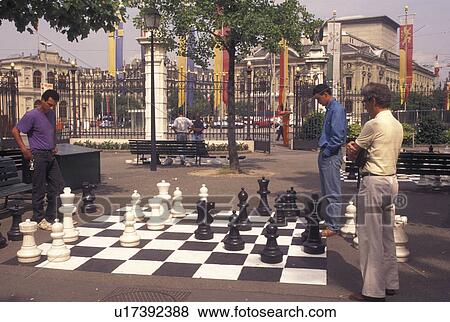 game of chess, Geneva, Switzerland, Men playing a game of chess on a giant chessboard at the Promenade des Bastions in the city of Geneva. View Large Photo Image Stock Photo - game of chess, Geneva, Switzerland, Men playing a game of chess on a giant chessboard at the Promenade des Bastions in the city of Geneva.. Fotosearch