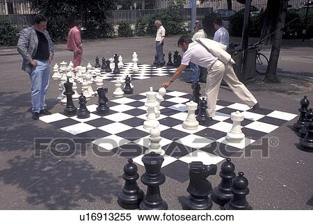 Stock Photography -  game of chess, Geneva, Switzerland, Men playing a game of chess on a giant chessboard at the Promenade des Bastions in the city of Geneva.. Fotosearch
