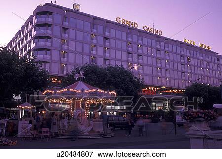 Geneva, Switzerland, Carrousel outside the Grand Casino Noga Hilton Hotel in downtown Geneva in the evening., View Large Photo Image Stock Photo - Geneva, Switzerland, Carrousel outside the Grand Casino Noga Hilton Hotel in downtown Geneva in the evening., . Fotosearch
