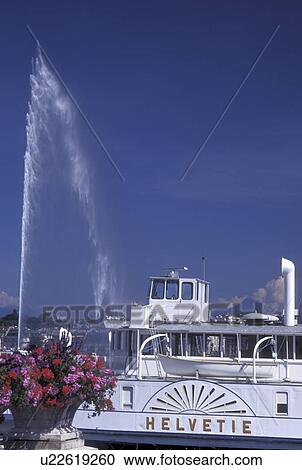 Geneva, Switzerland, Lake Geneva, Jet d' Eau sprays above a paddlewheel sightseeing boat docked at the marina in the harbor of Lac Leman in Geneva. View Large Photo Image Stock Image - Geneva, Switzerland, Lake Geneva, Jet d' Eau sprays above a paddlewheel sightseeing boat docked at the marina in the harbor of Lac Leman in Geneva. . Fotosearch