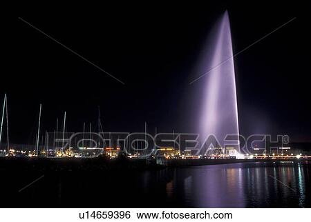 Stock Photograph -  Geneva, Switzerland, Lake Geneva, Jet d' Eau on the waterfront of Lac Leman in Geneva at night. . Fotosearch