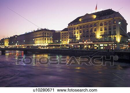 Stock Image -  Geneva, Switzerland, Rhone River, Buildings along the Rhone River in downtown Geneva at night. . Fotosearch