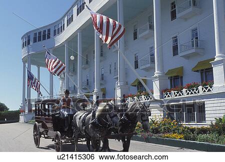 Stock Photograph -  Grand Hotel, carriage tours, Mackinac Island, MI, Lake Huron, Michigan, Carriage ride in front of the Historic Grand Hotel on Mackinac Island.. Fotosearch