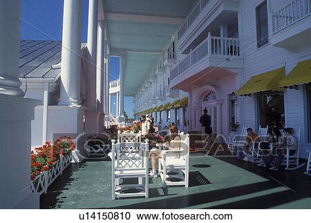 Stock Image -  Grand Hotel, Mackinac Island, MI, Lake Huron, Michigan, Hotel guests sitting on the veranda of Historic Grand Hotel on Mackinac Island.. Fotosearch