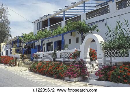 Greece, Ios, Greek Islands, Cyclades, Hora, Europe, Outdoor restaurant at a resort on Milopotas Beach on Ios Island on the Aegean Sea. View Large Photo Image Stock Image - Greece, Ios, Greek Islands, Cyclades, Hora, Europe, Outdoor restaurant at a resort on Milopotas Beach on Ios Island on the Aegean Sea.. Fotosearch