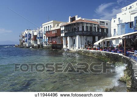 Greece, Mykonos, Greek Islands, Cyclades, Europe, Outdoor cafT at Little Venice along the waterfront of Mykonos on the Aegean Sea. View Large Photo Image Stock Photograph - Greece, Mykonos, Greek Islands, Cyclades, Europe, Outdoor cafT at Little Venice along the waterfront of Mykonos on the Aegean Sea.. Fotosearch