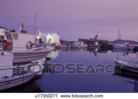 Stock Image -  Greece, Paros, Greek Islands, Naoussa, Cyclades, Europe, Fishing boats docked on the waterfront on Naoussa Harbor on Paros Island on the Aegean Sea.. Fotosearch