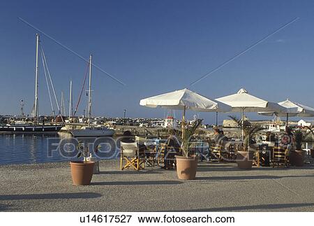 Greece, Paros, Greek Islands, Naoussa, Cyclades, Europe, Outdoor cafT along the waterfront in the town of Naoussa on Paros Island on the Aegean Sea. View Large Photo Image Stock Photo - Greece, Paros, Greek Islands, Naoussa, Cyclades, Europe, Outdoor cafT along the waterfront in the town of Naoussa on Paros Island on the Aegean Sea.. Fotosearch