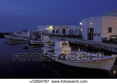 Stock Photo -  Greece, Paros, Naoussa, Greek Islands, Cyclades, Europe, Fishing boats docked on the waterfront on Naoussa Harbor in the evening on Paros Island on the Aegean Sea.. Fotosearch
