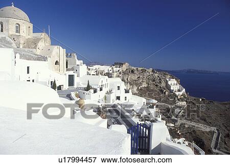 Stock Photo -  Greece, Santorini, Greek Islands, Oia, Cyclades, Europe, Whitewashed buildings in the village of Oia on the steep hillside of Santorini Island on the Aegean Sea.. Fotosearch