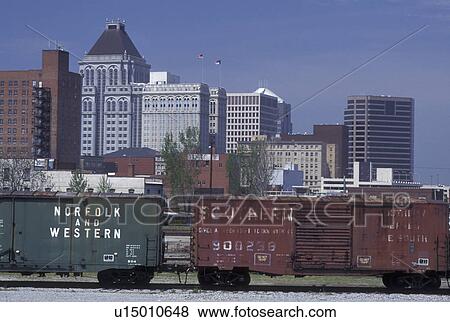 Stock Photo -  Greensboro, NC, North Carolina, Freight train travels past the skyline of downtown Greensboro. Fotosearch