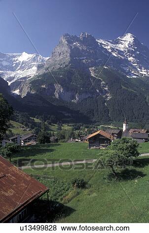 Stock Photo -  Grindenwald, Switzerland, Berne, Bern, Bernese Oberland, Scenic view of the alpine resort town of Grindenwald and the Bernese Alps.. Fotosearch