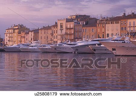 harbor, St. Tropez, France, Cote d' Azur, Provence, Var, Europe, Yachts docked in the harbor of Saint Tropez at sunset on the Mediterranean Sea. View Large Photo Image Stock Photo - harbor, St. Tropez, France, Cote d' Azur, Provence, Var, Europe, Yachts docked in the harbor of Saint Tropez at sunset on the Mediterranean Sea.. Fotosearch
