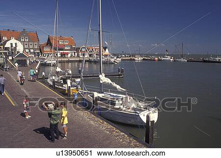 Holland, Volendam, Netherlands, Noord-Holland, Europe, People along the waterfront on the harbor on Markermeer in the town of Volendam. View Large Photo Image Stock Image - Holland, Volendam, Netherlands, Noord-Holland, Europe, People along the waterfront on the harbor on Markermeer in the town of Volendam.. Fotosearch