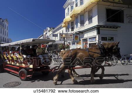 horse drawn carriage, Mackinac Island, MI, Lake Huron, Michigan, Carriage ride down the Main Street downtown Mackinac Island on Lake Huron. View Large Photo Image Stock Image - horse drawn carriage, Mackinac Island, MI, Lake Huron, Michigan, Carriage ride down the Main Street downtown Mackinac Island on Lake Huron.. Fotosearch
