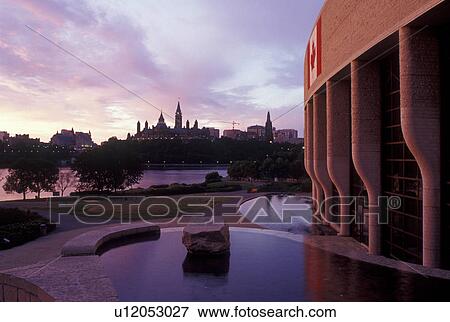 Hull, Canada, Quebec, Canadian Museum of Civilization (Musee Canadian des Civilisations) in the city of Hull. Parliament Hill at sunrise across the Ottawa River in Ottawa, Ontario. View Large Photo Image Stock Photo - Hull, Canada, Quebec, Canadian Museum of Civilization (Musee Canadian des Civilisations) in the city of Hull. Parliament Hill at sunrise across the Ottawa River in Ottawa, Ontario.. Fotosearch