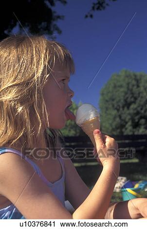ice cream cone, Switzerland, Vaud, Lake Geneva, 8 year old girl licking vanilla ice cream on a cone. View Large Photo Image Stock Image - ice cream cone, Switzerland, Vaud, Lake Geneva, 8 year old girl licking vanilla ice cream on a cone.. Fotosearch