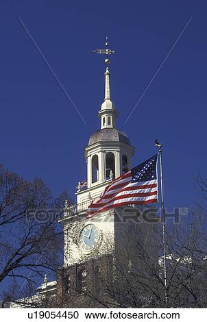 Stock Image -  Independence Hall, American Flag, Philadelphia, Pennsylvania, PA, The American flag and steeple of Independence Hall at Independence National Historical Park in downtown Philadelphia.. Fotosearch