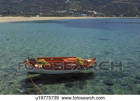 Stock Photo -  Ios, Greek Islands, Cyclades, Greece, Europe, Fishing boat buoyed along Milopotas Beach on Ios Island on the Aegean Sea.. Fotosearch