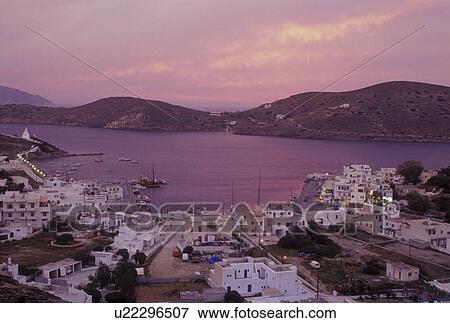 Stock Photo -  Ios, Greek Islands, Cyclades, Greece, Ormos, Europe, Sunset over Ormos harbor from Hora on Ios Island on the Aegean Sea.. Fotosearch