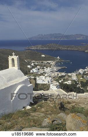 Stock Photograph -  Ios, Greek Islands, Cyclades, Ormos, Greece, Europe, Scenic view of Ormos harbor from a whitewashed church in Hora on Ios Island on the Aegean Sea.. Fotosearch