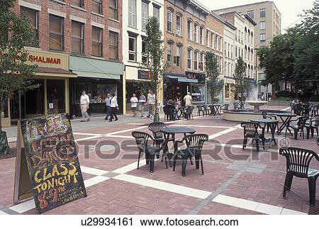 Stock Image -  Ithaca, NY, New York, Finger Lakes, Outdoor cafT at Ithaca Commons in downtown Ithaca.. Fotosearch