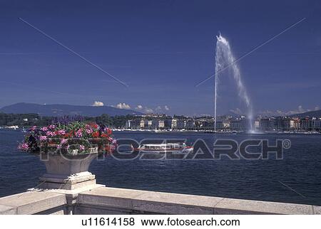 Jet d' Eau, Geneva, Switzerland, Lake Geneva, Water taxi cruises by the tall Jet d' Eau on Lac Leman in Geneva. View Large Photo Image Stock Photo - Jet d' Eau, Geneva, Switzerland, Lake Geneva, Water taxi cruises by the tall Jet d' Eau on Lac Leman in Geneva. . Fotosearch