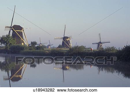 Kinderdijk, Holland, windmill, canal, Netherlands, Zuid-Holland, Europe, Mills of Kinderdijk, Working windmills along a canal in Kinderdijk. View Large Photo Image Stock Image - Kinderdijk, Holland, windmill, canal, Netherlands, Zuid-Holland, Europe, Mills of Kinderdijk, Working windmills along a canal in Kinderdijk. . Fotosearch