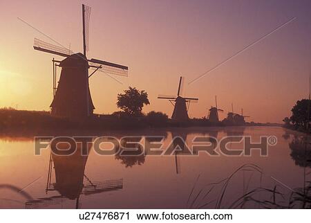Kinderdijk, Holland, windmill, canal, Netherlands, Zuid-Holland, Europe, Mills of Kinderdijk, Working windmills along a canal in the early morning mist in Kinderdijk. View Large Photo Image Stock Image - Kinderdijk, Holland, windmill, canal, Netherlands, Zuid-Holland, Europe, Mills of Kinderdijk, Working windmills along a canal in the early morning mist in Kinderdijk. . Fotosearch