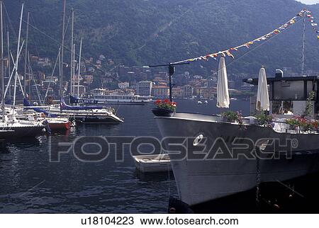 Lake Como, Italy, Como, Lombardy, Lombardia, Southern Alps, Boats docked at a marina on Lake Como in the harbor of the village of Como. View Large Photo Image Stock Image - Lake Como, Italy, Como, Lombardy, Lombardia, Southern Alps, Boats docked at a marina on Lake Como in the harbor of the village of Como.. Fotosearch