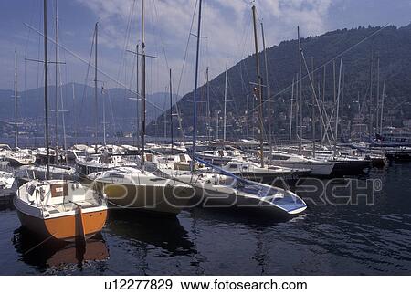 Lake Como, Italy, Como, Lombardy, Lombardia, Southern Alps, Boats docked at a marina on Lake Como in the harbor of the village of Como. View Large Photo Image Stock Photo - Lake Como, Italy, Como, Lombardy, Lombardia, Southern Alps, Boats docked at a marina on Lake Como in the harbor of the village of Como.. Fotosearch