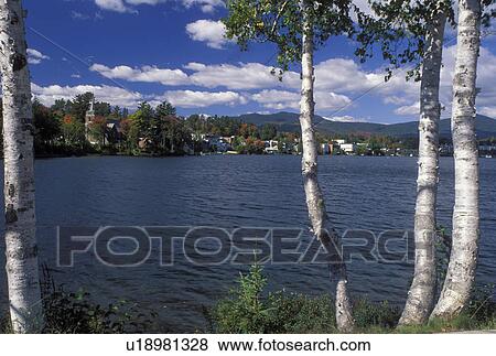 Lake Placid, New York, The Adirondacks, NY, Scenic view of the resort town of Lake Placid thru birch tree along Mirror Lake in the autumn. View Large Photo Image Stock Photo - Lake Placid, New York, The Adirondacks, NY, Scenic view of the resort town of Lake Placid thru birch tree along Mirror Lake in the autumn.. Fotosearch
