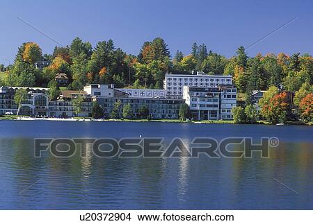 Lake Placid, NY, The Adirondacks, New York, Scenic view of the resort town of Lake Placid along Mirror Lake in the autumn. View Large Photo Image Picture - Lake Placid, NY, The Adirondacks, New York, Scenic view of the resort town of Lake Placid along Mirror Lake in the autumn.. Fotosearch