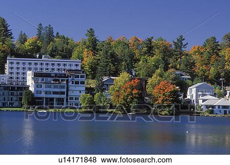 Stock Photo -  Lake Placid, The Adirondacks, NY, New York, Scenic view of the resort town of Lake Placid along Mirror Lake in the autumn.. Fotosearch