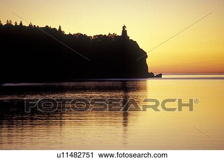 Stock Image -  Lake Superior, North Shore Drive, Two Harbors, MN, Minnesota, Split Rock Lighthouse situated on a high cliff on the north shore of Lake Superior at Split Rock Lighthouse State Park in Two Harbors at sunrise.. Fotosearch