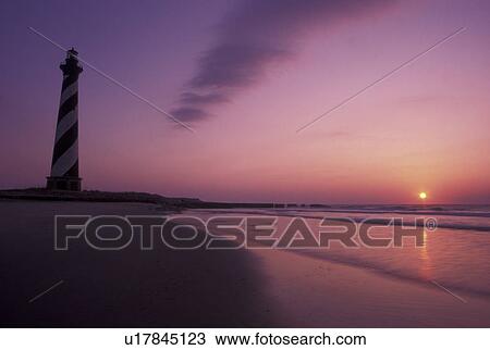 Stock Image -  lighthouse, Cape Hatteras National Seashore, Outer Banks, North Carolina, NC, Cape Hatteras Lighthouse at sunrise on Cape Hatteras Nat'l Seashore on the Outer Banks.. Fotosearch