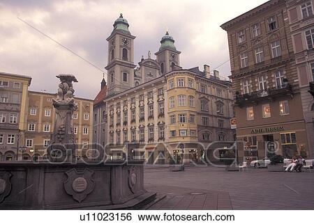 Stock Photograph -  Linz, Austria, The Danube Valley, Oberosterreich, Fountain at Hauptplatz and Old Cathedral in downtown Linz.. Fotosearch