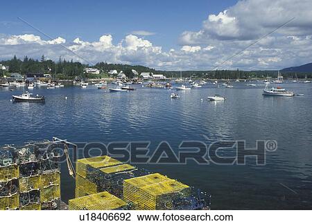 Stock Image -  lobster traps, ME, Bass Harbor, Maine, Mount Desert Island, Lobster fishing boats buoyed in the harbor and lobster trap in the fishing village of Bass Harbor on the Atlantic Ocean.. Fotosearch