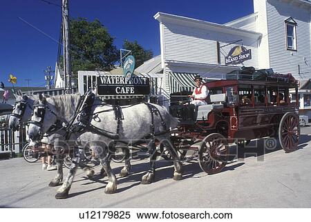 Mackinac Island, horse drawn carriage, MI, Lake Huron, Michigan, Carriage ride down the Main Street downtown Mackinac Island on Lake Huron. View Large Photo Image Stock Photography - Mackinac Island, horse drawn carriage, MI, Lake Huron, Michigan, Carriage ride down the Main Street downtown Mackinac Island on Lake Huron.. Fotosearch