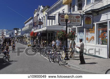 Stock Photo -  Mackinac Island, MI, Lake Huron, Michigan, Main Street downtown Mackinac Island on Lake Huron.. Fotosearch