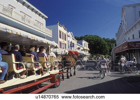 Mackinac Island, MI, Lake Huron, Michigan, Carriage ride down the Main Street downtown Mackinac Island on Lake Huron. View Large Photo Image Stock Photography - Mackinac Island, MI, Lake Huron, Michigan, Carriage ride down the Main Street downtown Mackinac Island on Lake Huron.. Fotosearch
