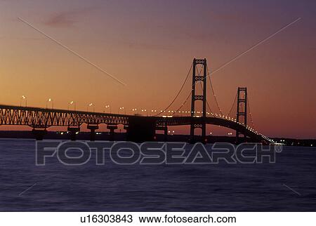 Mackinaw City, MI, Michigan, Upper Peninsula, View of Mackinac Bridge, a suspension span bridge, in the evening crosses the Straits of Mackinaw in Mackinaw City connecting the Lower Peninsula with the Upper Peninsula of Michigan. View Large Photo Image Stock Image -  Mackinaw City, MI, Michigan, Upper Peninsula, View of Mackinac Bridge, a suspension span bridge, in the evening crosses the Straits of Mackinaw in Mackinaw City connecting the Lower Peninsula with the Upper Peninsula of Michigan.. Fotosearch